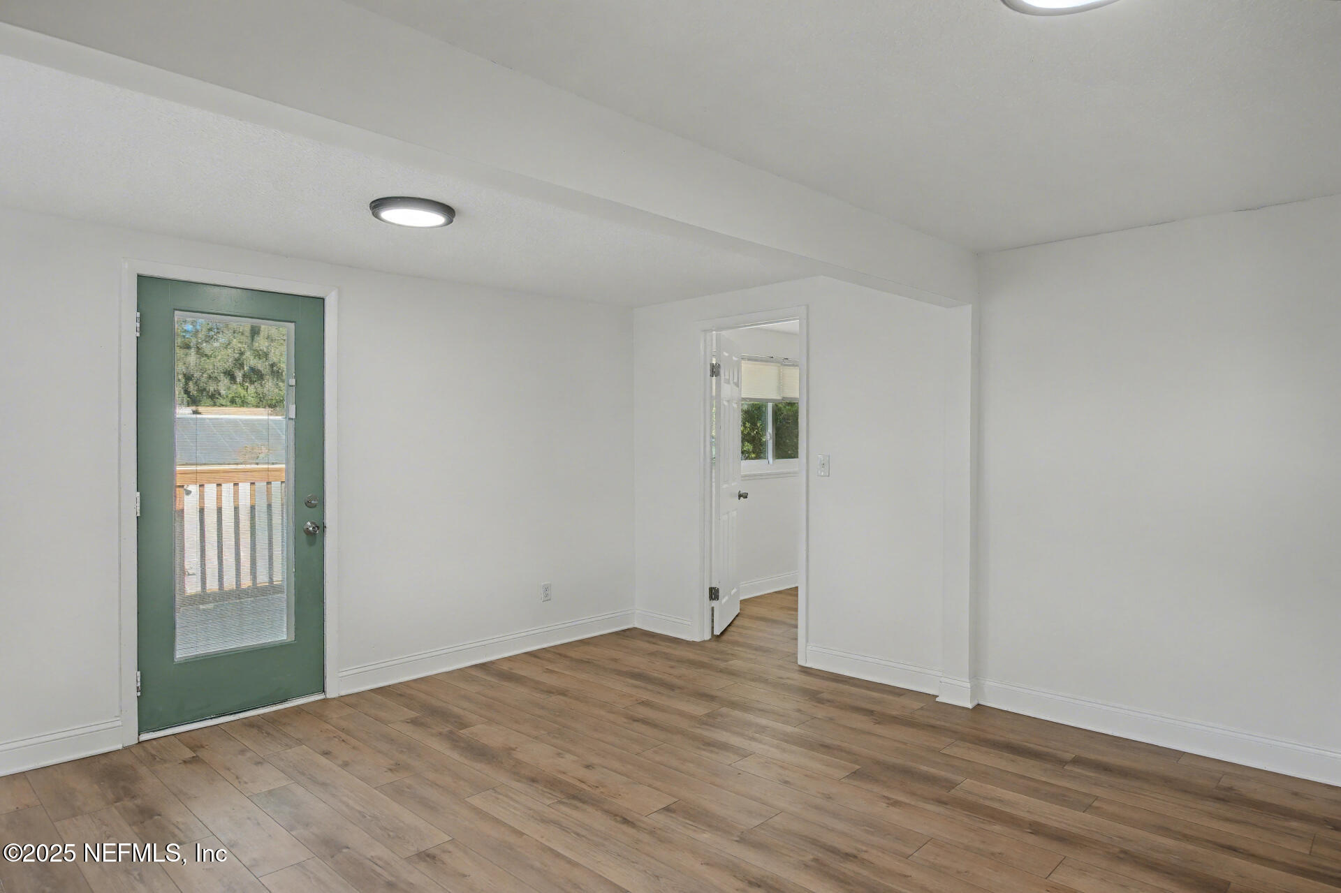 1503 Broome Street Fernandina Beach, FL 32034 - Photo 7 of 38 a view of an empty room with wooden floor and a window