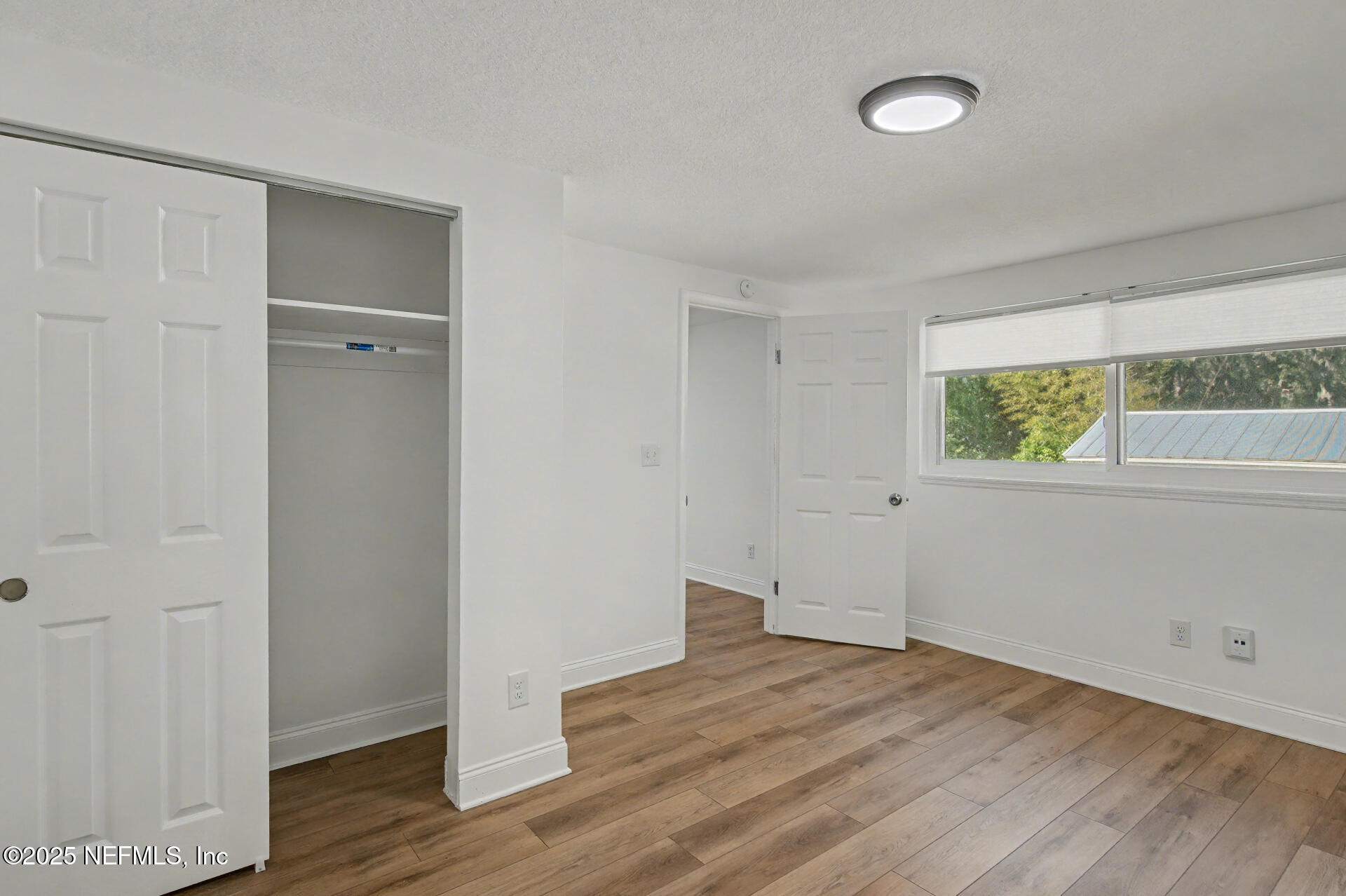 1503 Broome Street Fernandina Beach, FL 32034 - Photo 8 of 38 an empty room with wooden floor and windows