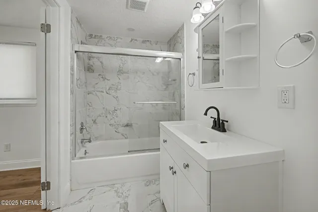 a bathroom with a sink a toilet and a shower