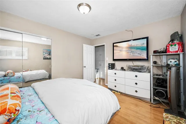 a bedroom with furniture and a flat screen tv