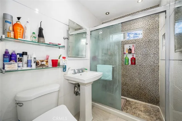 a bathroom with a sink mirror and toilet