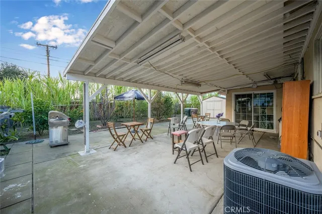 a view of a patio with chairs and potted plants