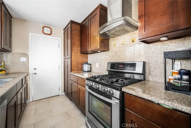 a kitchen with stainless steel appliances granite countertop a stove and a sink