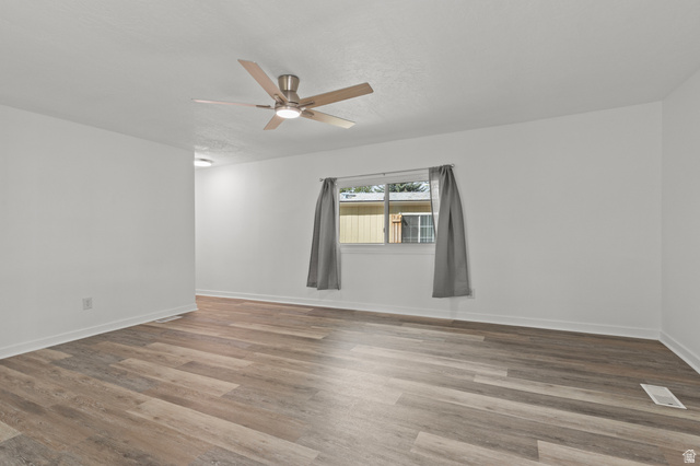350 West 800 South, Unit 2 Logan, UT 84321 - Photo 2 of 22 Spare room featuring a ceiling fan and wood finished floors