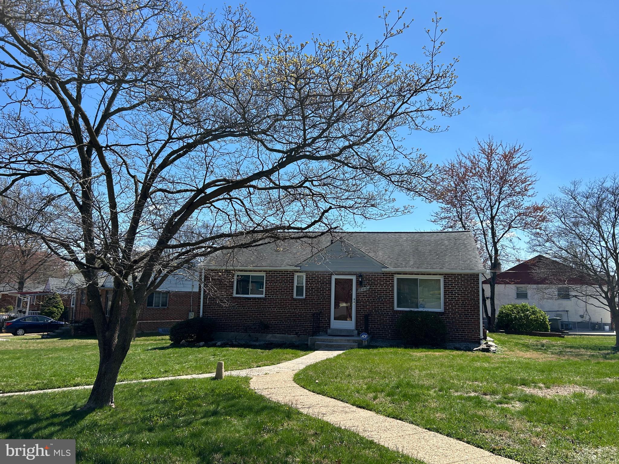11015 Burnley Terrace Silver Spring, MD 20902 - Photo 2 of 4 a front view of a house with a garden and trees