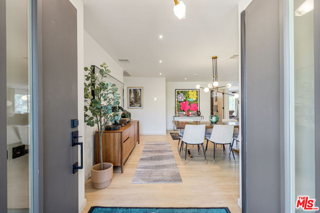 66869 San Ardo Road Desert Hot Springs, CA 92240 - Photo 7 of 39 a dining room with furniture potted plants and wooden floor