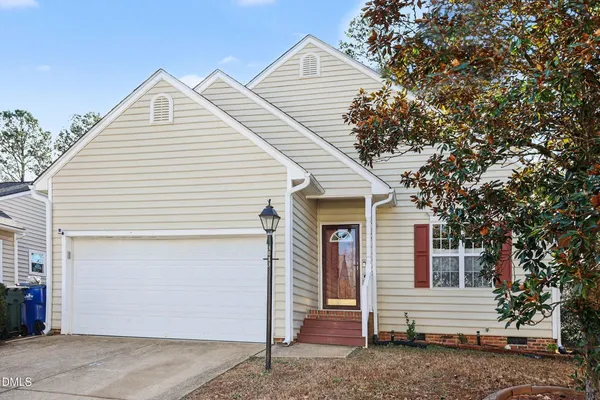 a kitchen with stainless steel appliances granite countertop a stove top oven a refrigerator with white cabinets and wooden floor