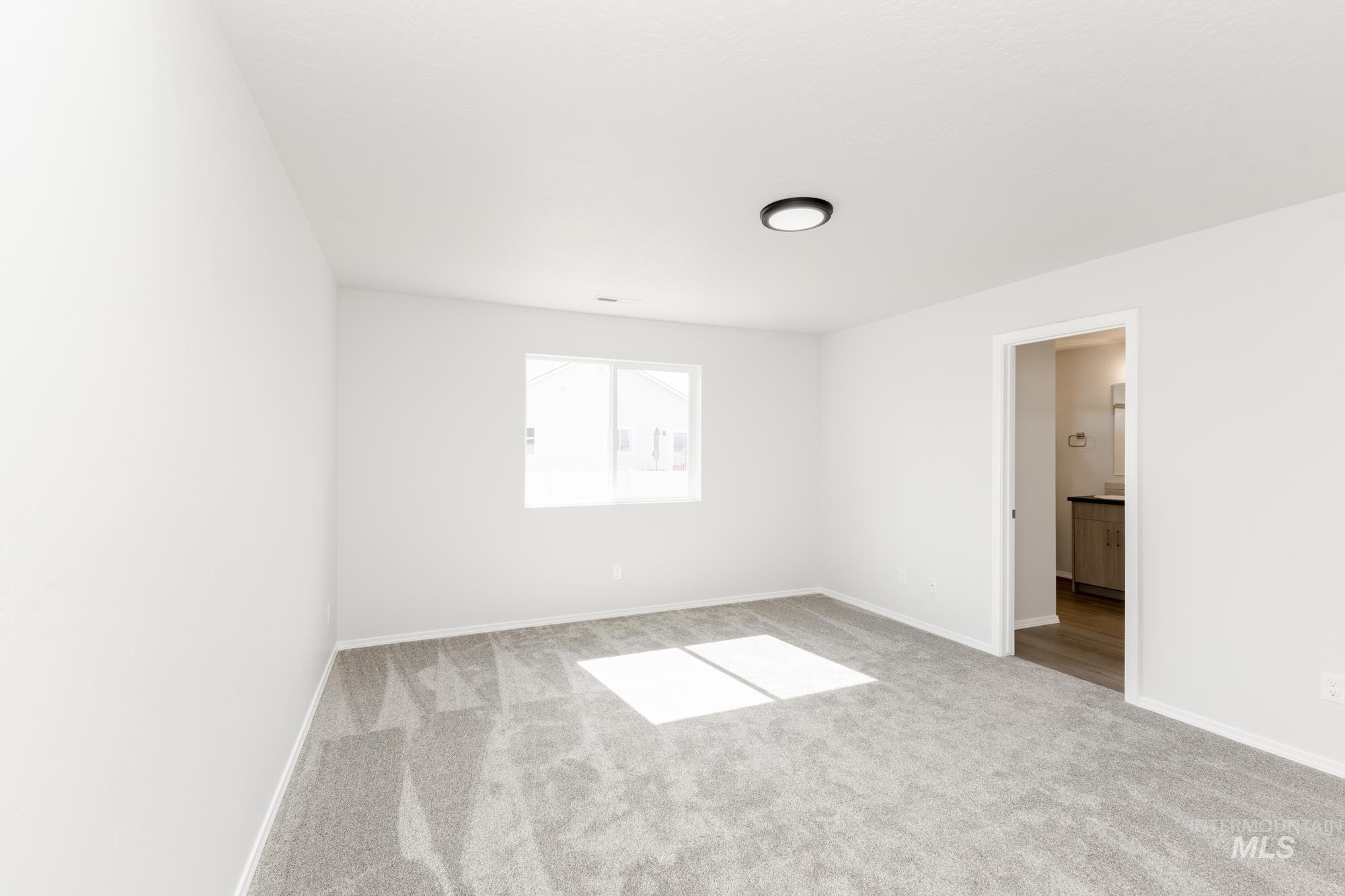 1611 Sunday River Street Middleton, ID 83644 - Photo 12 of 17 Spare room with light colored carpet and baseboards
