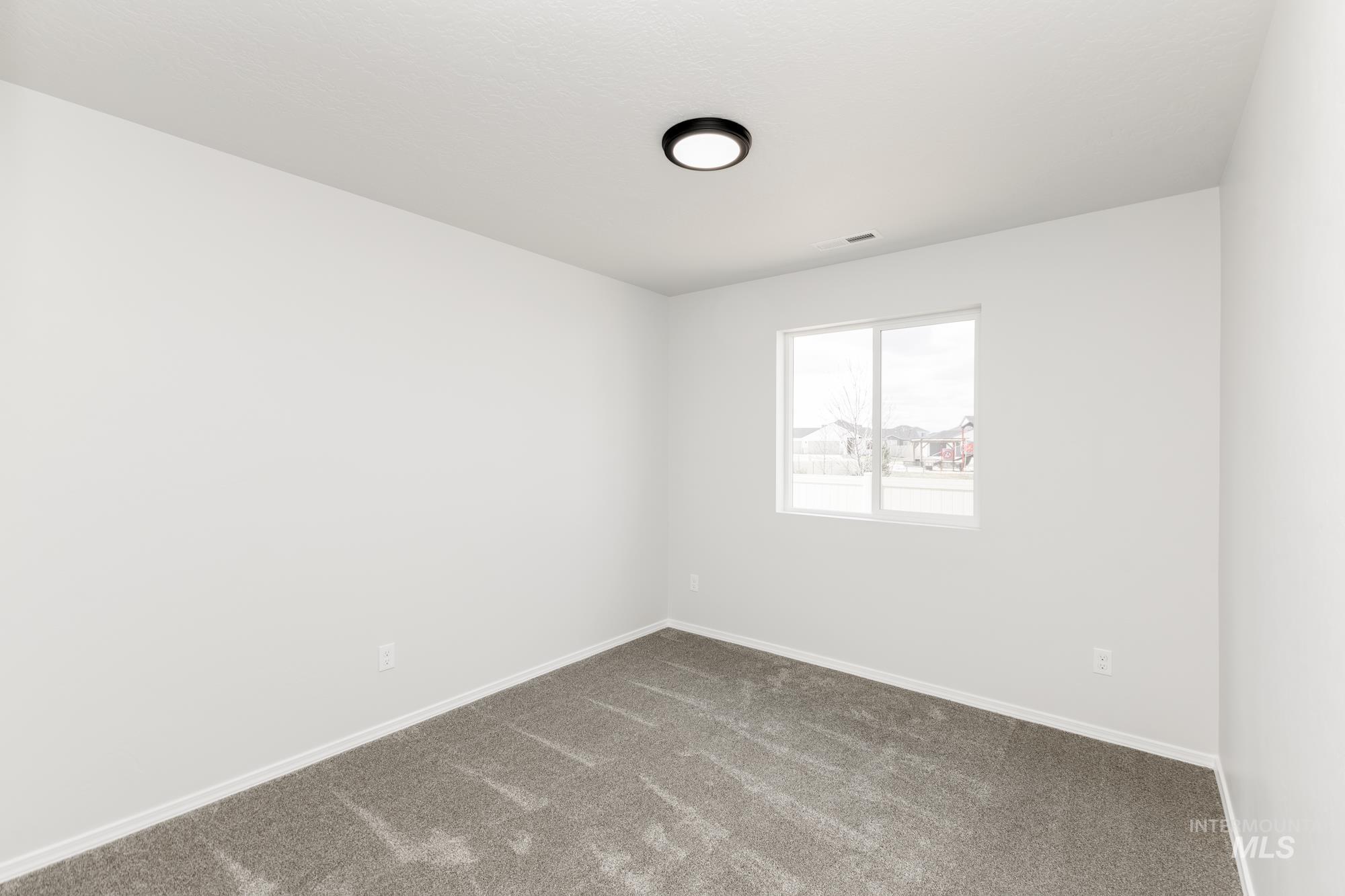 1611 Sunday River Street Middleton, ID 83644 - Photo 7 of 17 Empty room featuring carpet floors and baseboards