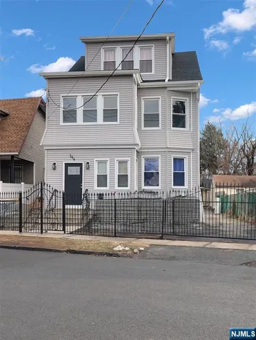 a front view of a house with a street