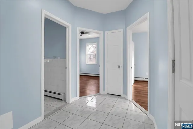 an empty room with closet and a hallway