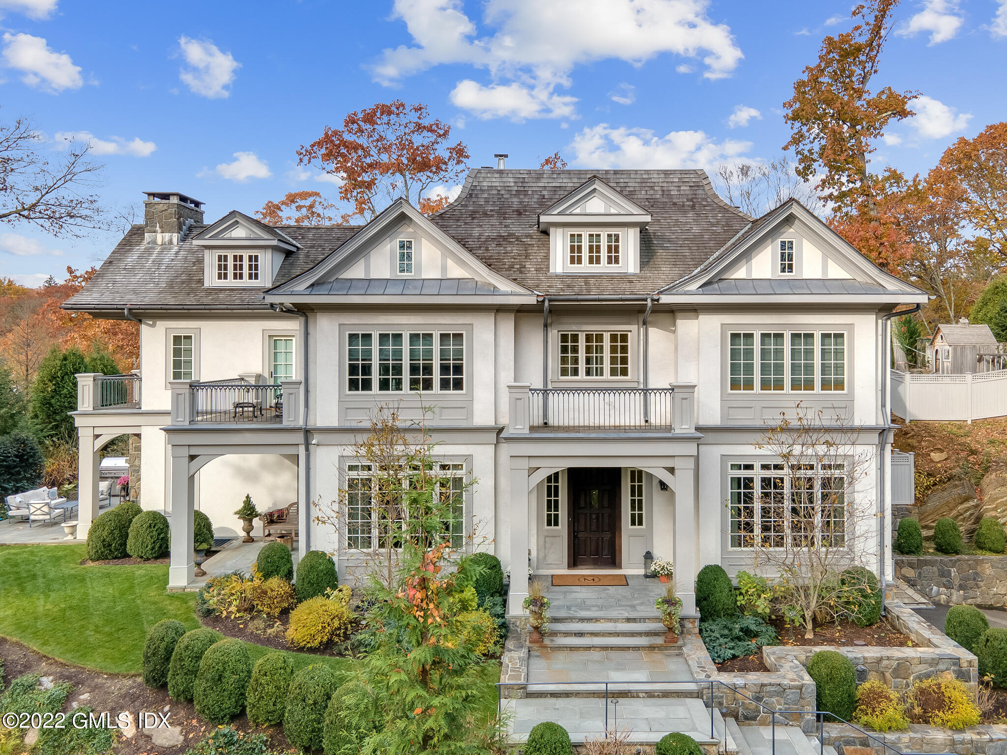 a front view of a house with a garden
