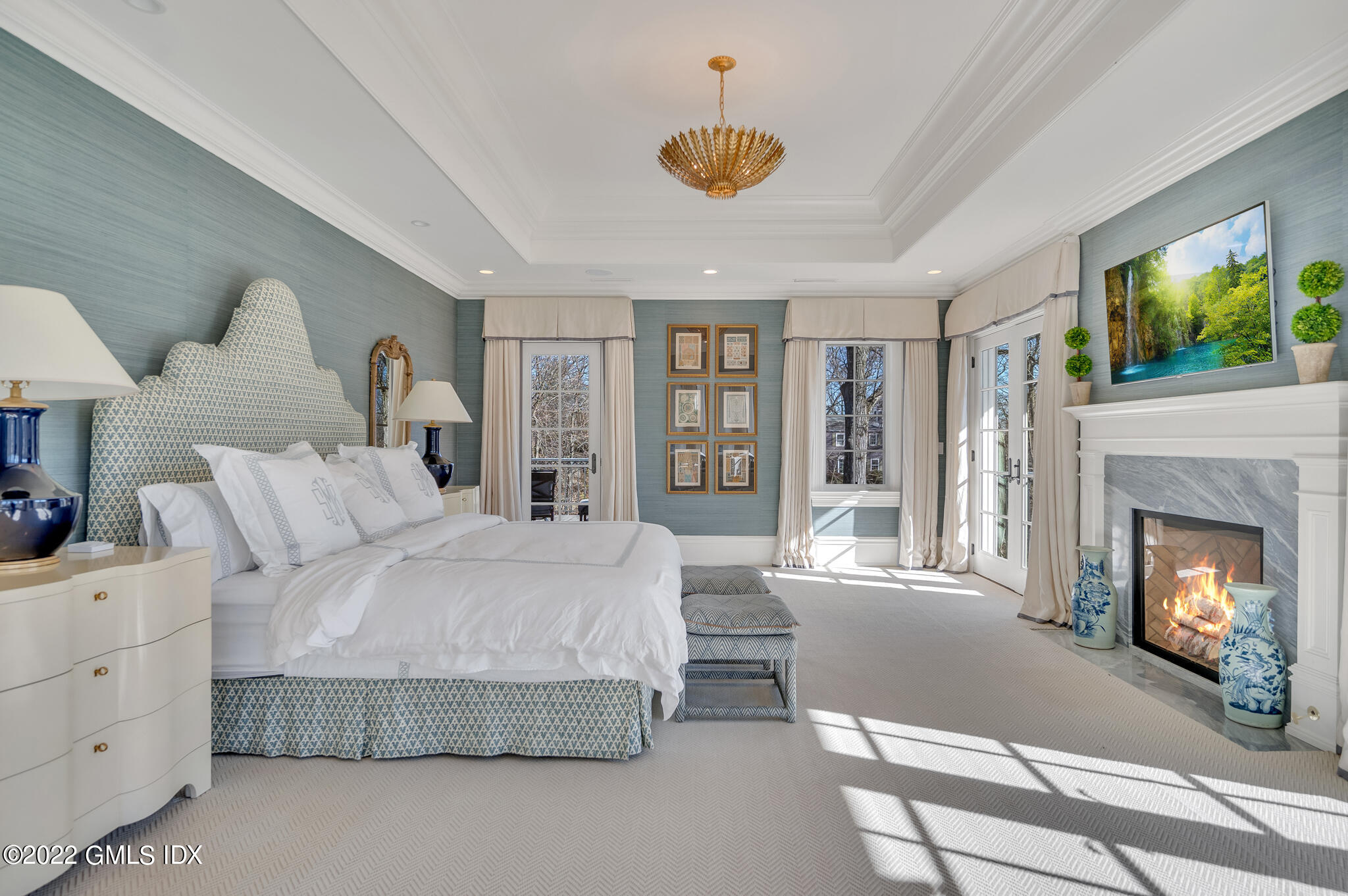 21 Woodside Drive Greenwich, CT 06830 - Photo 21 of 35 a spacious bedroom with a large bed and a fireplace