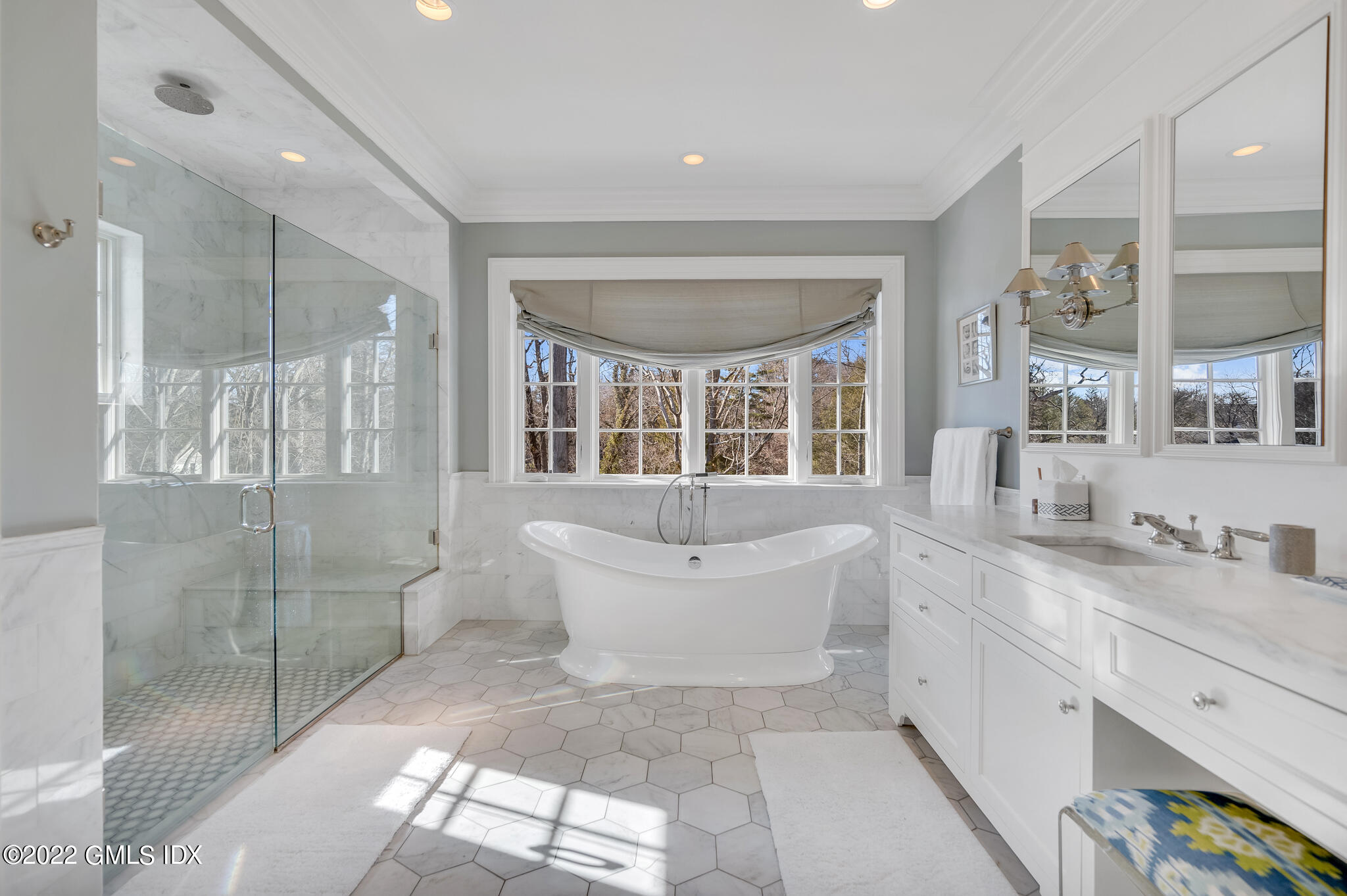 21 Woodside Drive Greenwich, CT 06830 - Photo 22 of 35 a bathroom with a double vanity sink a toilet a mirror and shower