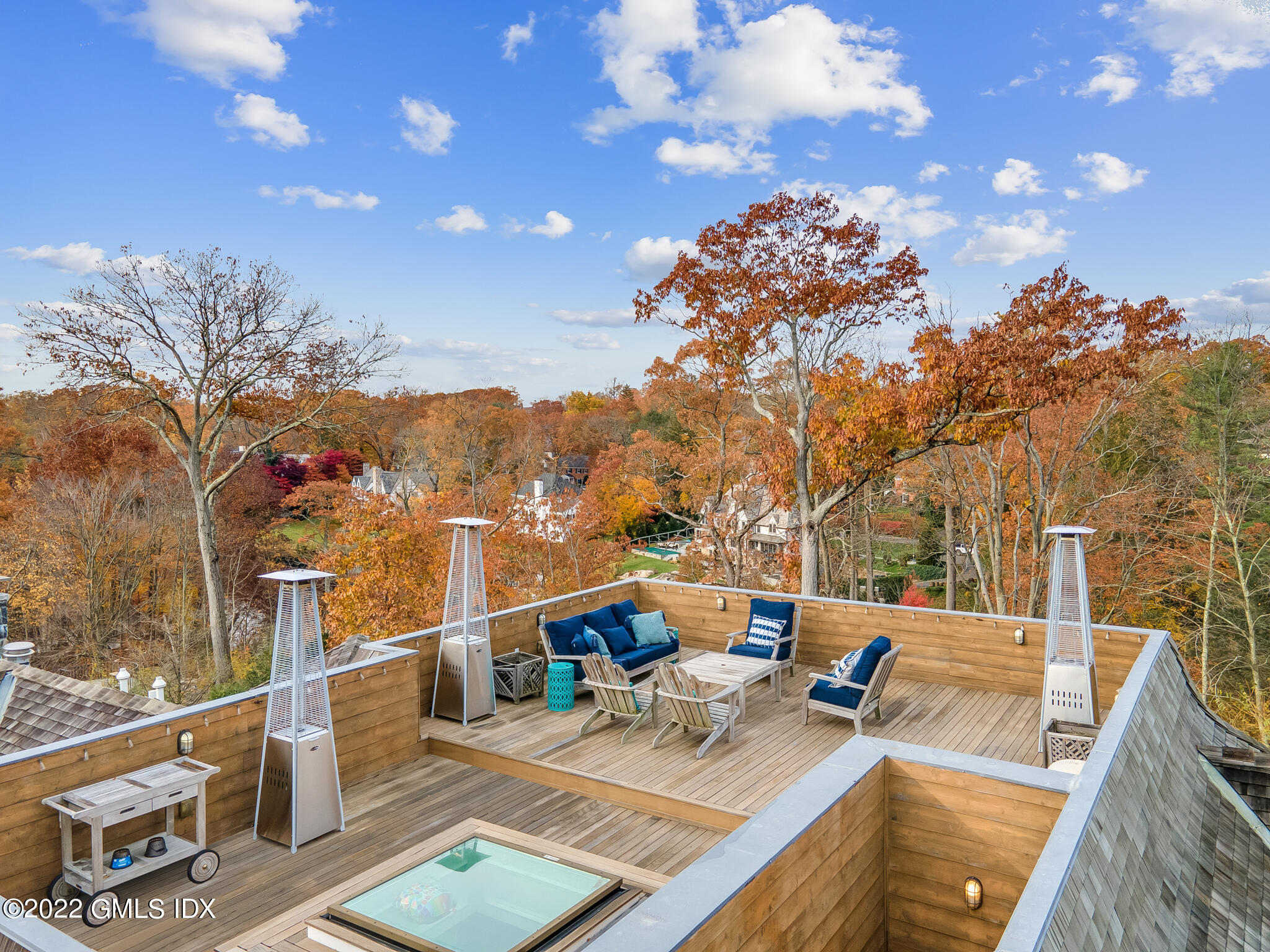 21 Woodside Drive Greenwich, CT 06830 - Photo 29 of 35 a view of a balcony with dining table and chairs with wooden floor and fence