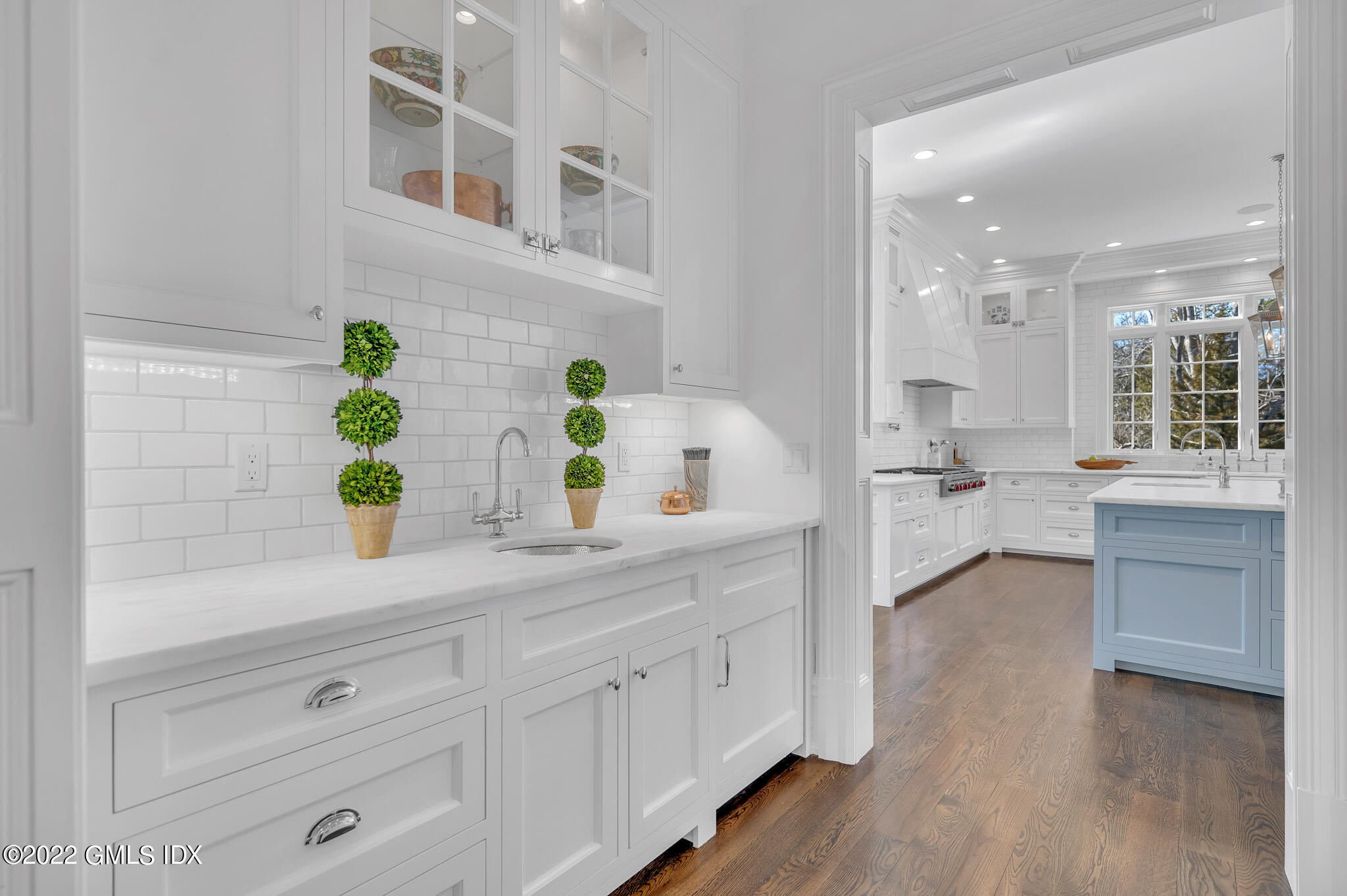 21 Woodside Drive Greenwich, CT 06830 - Photo 7 of 35 a view living room with stainless steel appliances white cabinets and wooden floor
