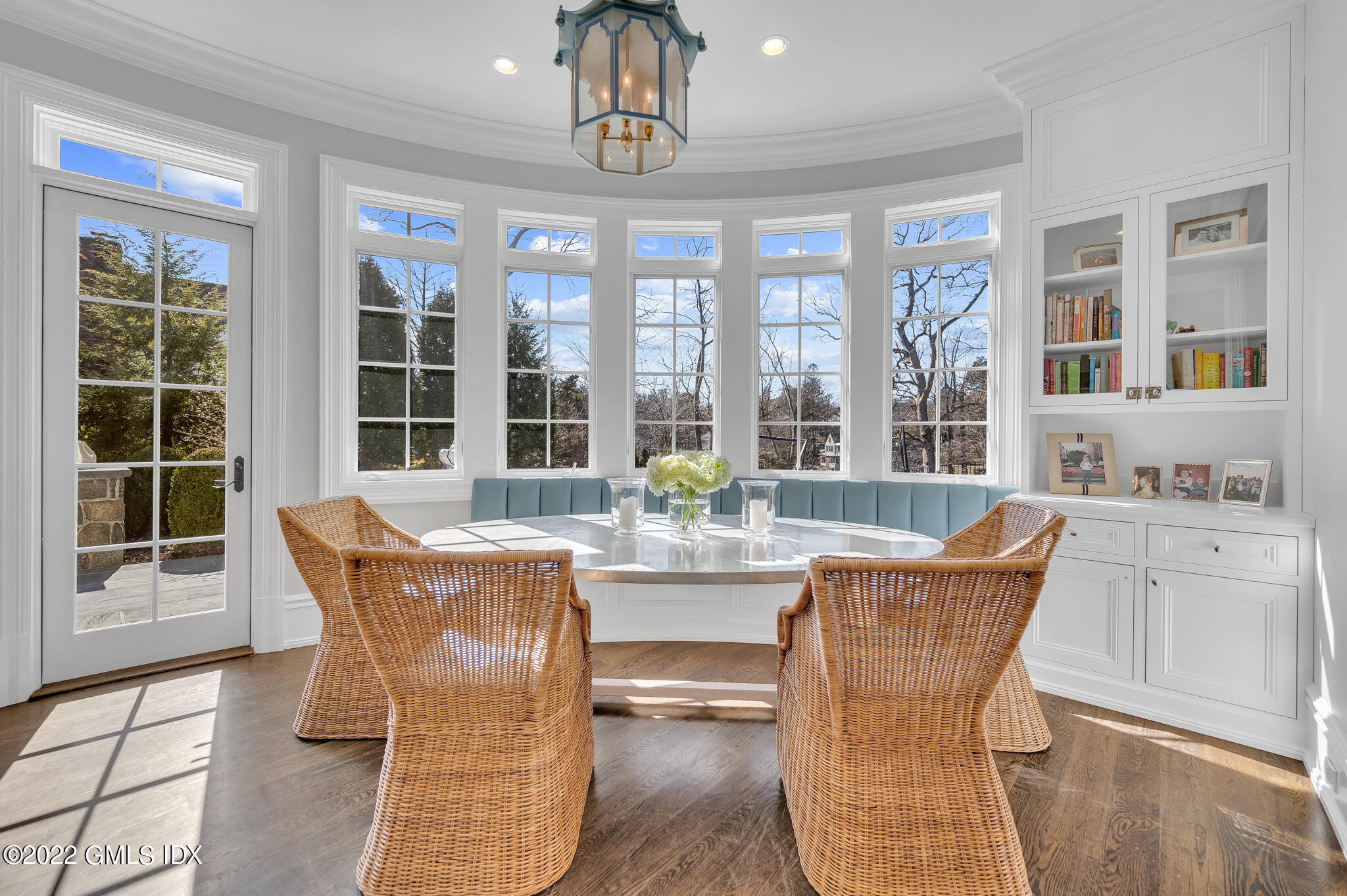 21 Woodside Drive Greenwich, CT 06830 - Photo 10 of 35 a dining room with wooden floor a chandelier a glass table and windows