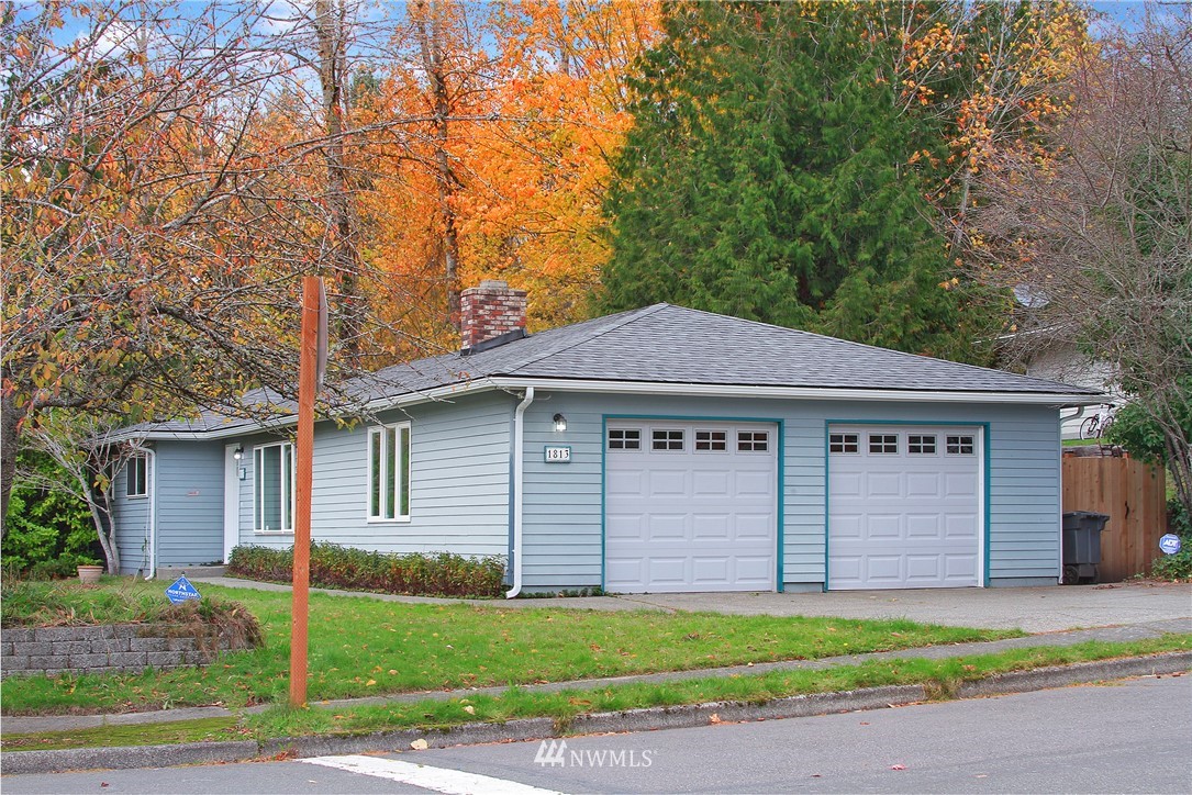 1813 Aberdeen Avenue Southeast Renton, WA 98055 - Photo 3 of 22 a front view of a house with a garden and garage