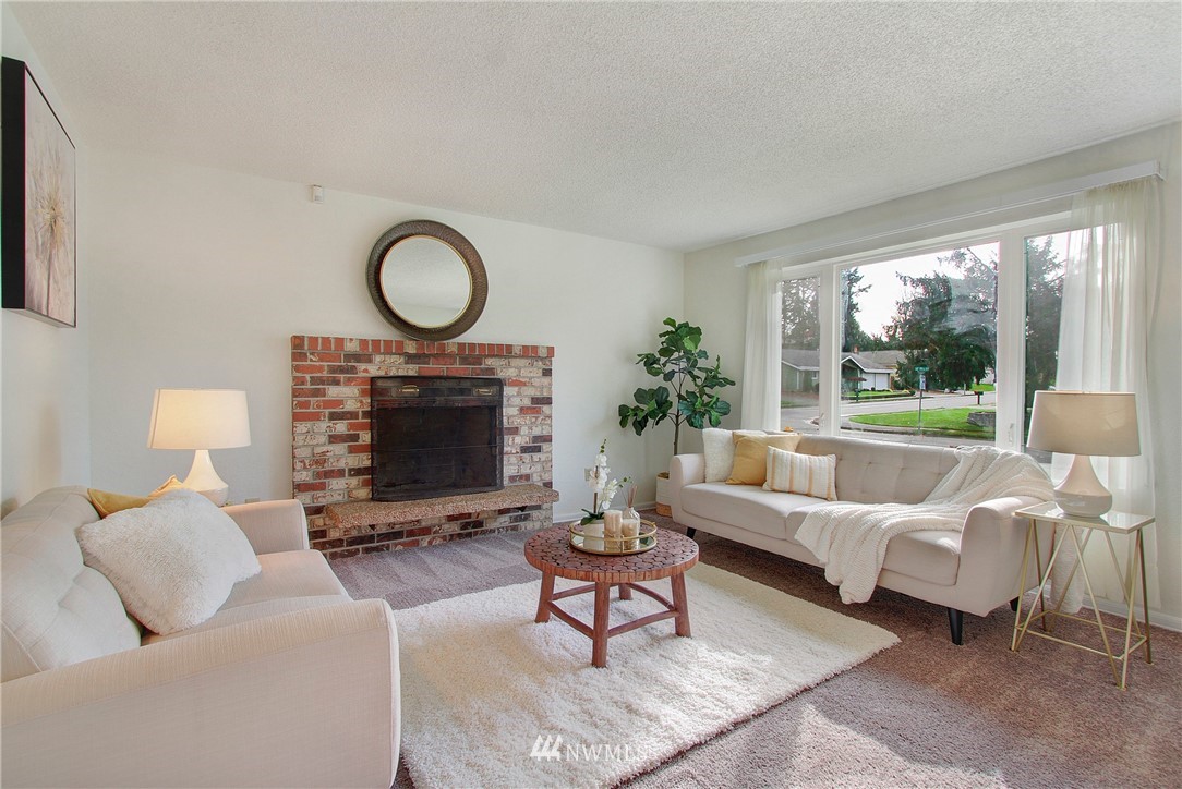 1813 Aberdeen Avenue Southeast Renton, WA 98055 - Photo 4 of 22 a living room with furniture a large window and a fireplace