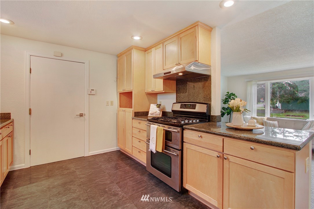 1813 Aberdeen Avenue Southeast Renton, WA 98055 - Photo 8 of 22 a kitchen with stainless steel appliances granite countertop a stove a sink and a refrigerator