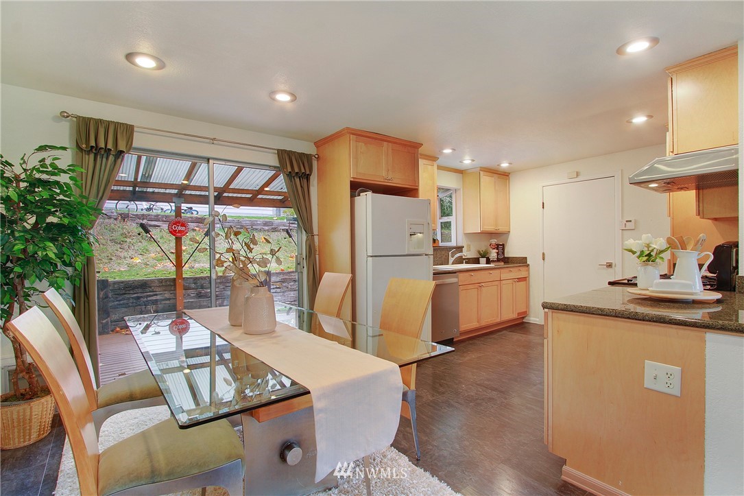 1813 Aberdeen Avenue Southeast Renton, WA 98055 - Photo 10 of 22 a kitchen with stainless steel appliances granite countertop a refrigerator a sink a stove and white cabinets with wooden floor