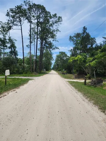 a view of a street sign and potted plants