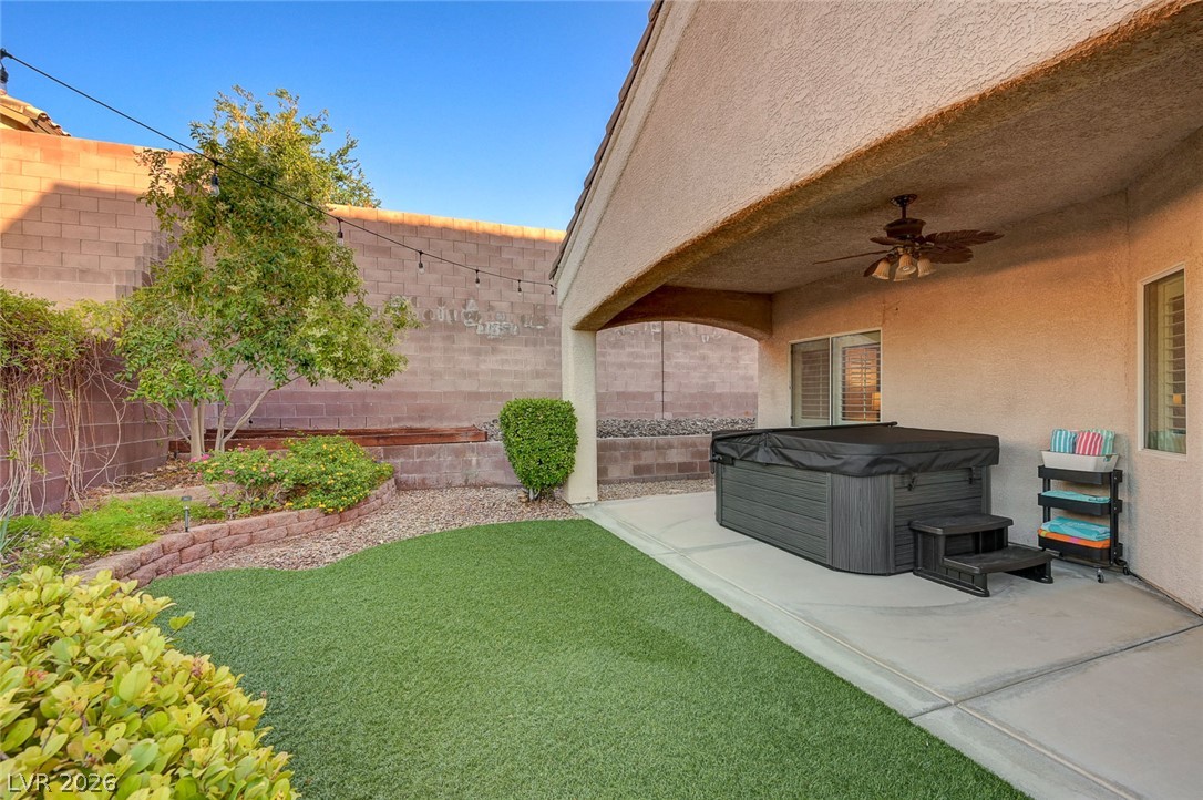1604 Cattle Ranch Place Henderson, NV 89002 - Photo 76 of 99 A private, inviting backyard offers both artificial turf and a covered patio with a spa.