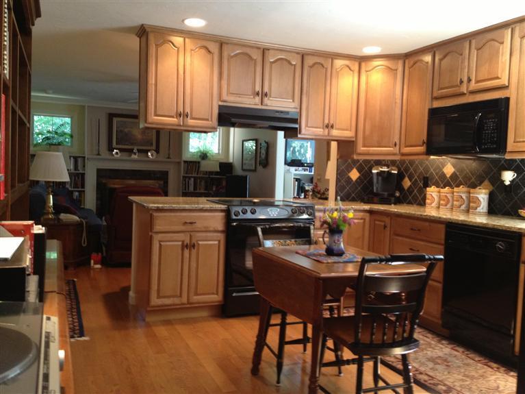 54 Ansel Howland Road Centerville, MA 02632 - Photo 2 of 19 a kitchen with granite countertop a sink stove and cabinets