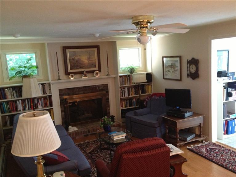 54 Ansel Howland Road Centerville, MA 02632 - Photo 4 of 19 a living room with furniture a flat screen tv and a fireplace
