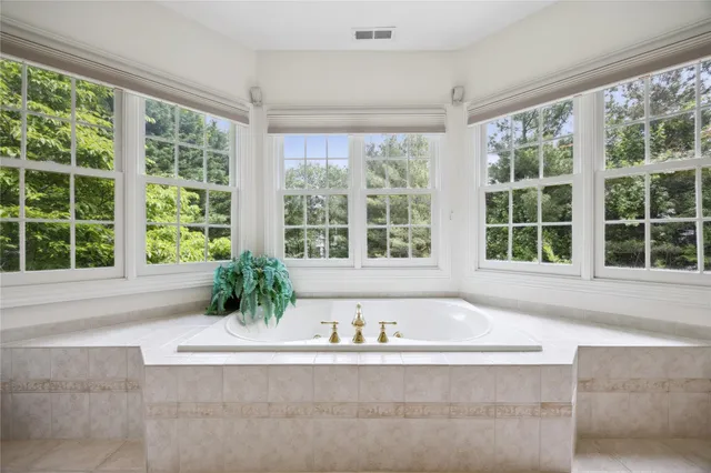 a spacious bathroom with a tub and shower