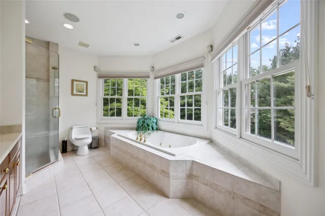 a living room with furniture a flat screen tv and a large window