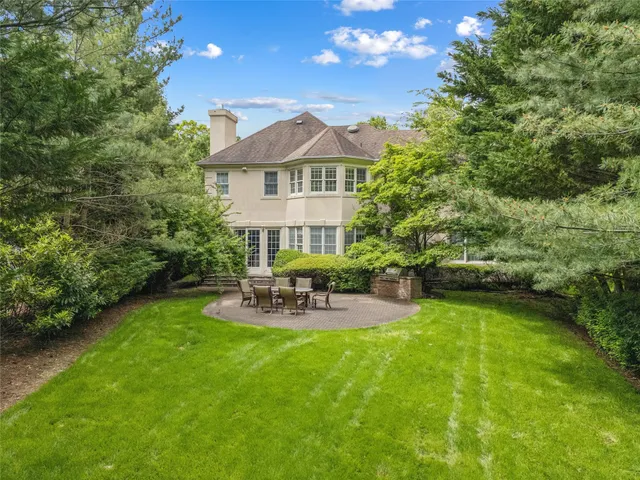 an aerial view of multiple houses with yard