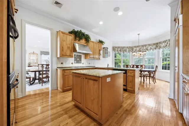 a kitchen with stainless steel appliances granite countertop sink stove top oven and cabinets