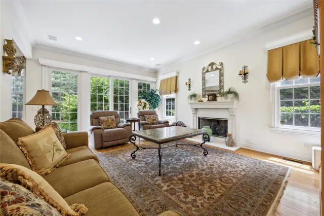 a living room with furniture a fireplace and a table