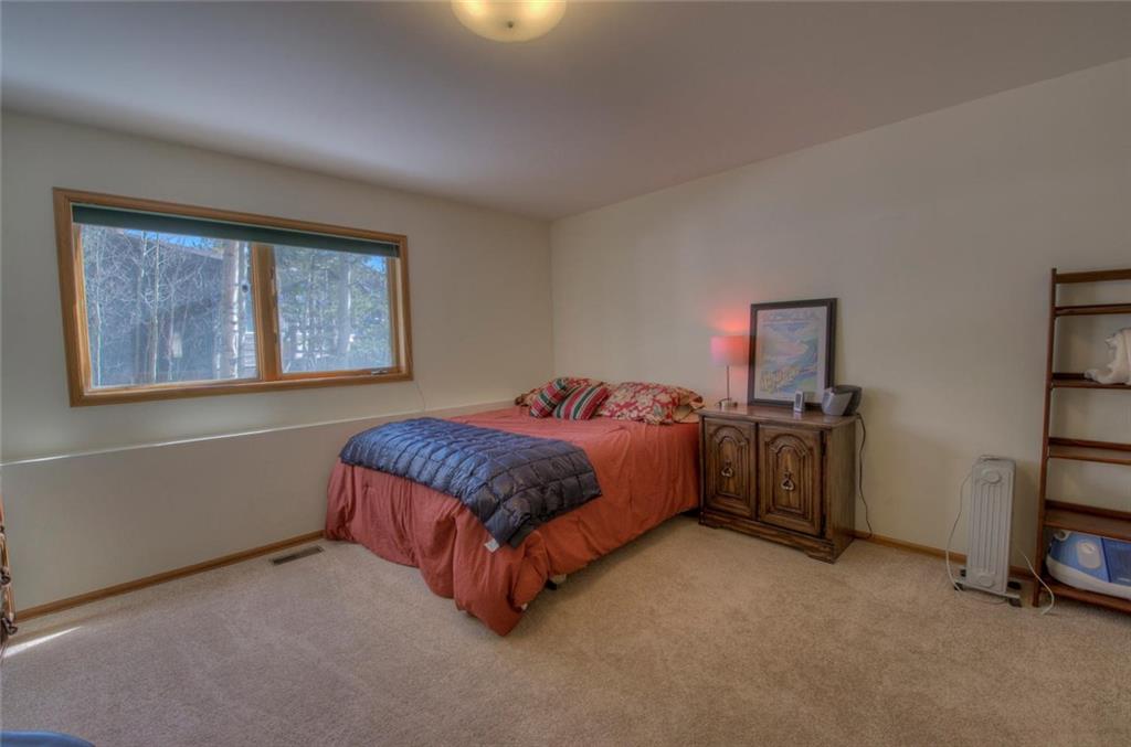 47 Spring Beauty Drive Silverthorne, CO 80498 - Photo 20 of 23 a spacious bedroom with a bed and a cabinets