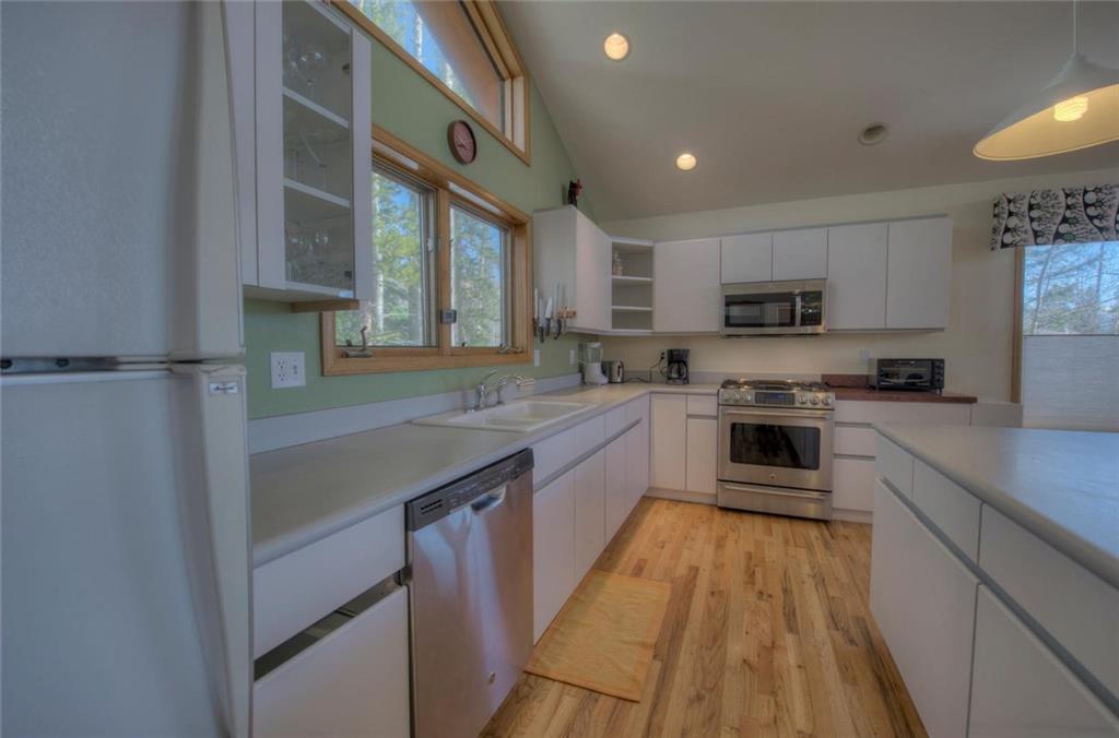 47 Spring Beauty Drive Silverthorne, CO 80498 - Photo 8 of 23 a kitchen with kitchen island granite countertop a sink a counter top space stainless steel appliances and cabinets