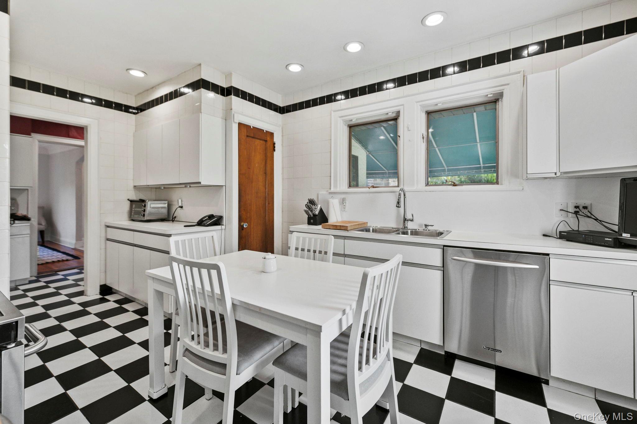 44 Fenimore Road New Rochelle, NY 10804 - Photo 13 of 46 a kitchen with a sink a stove and white cabinets