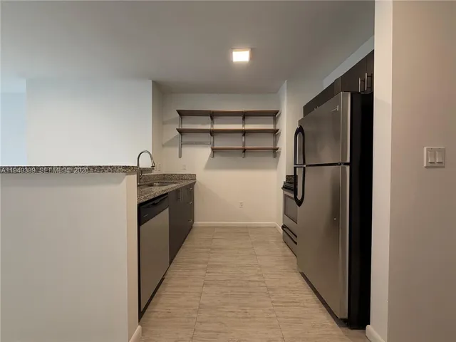 a kitchen with a refrigerator and a sink