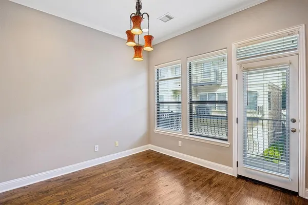 a view of a room with wooden floor and fan