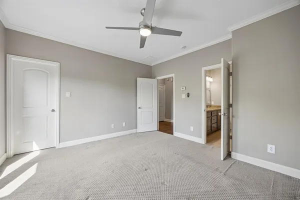 a view of an empty room and a ceiling fan