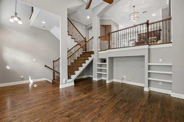 a kitchen with stainless steel appliances granite countertop a refrigerator a sink dishwasher a stove and oven with wooden floor