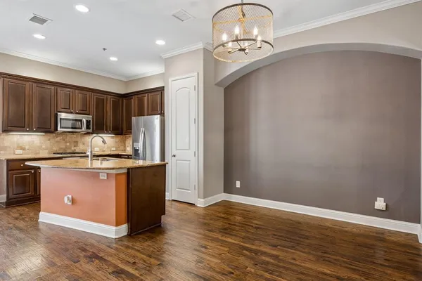 a view of a livingroom with furniture wooden floor chandelier
