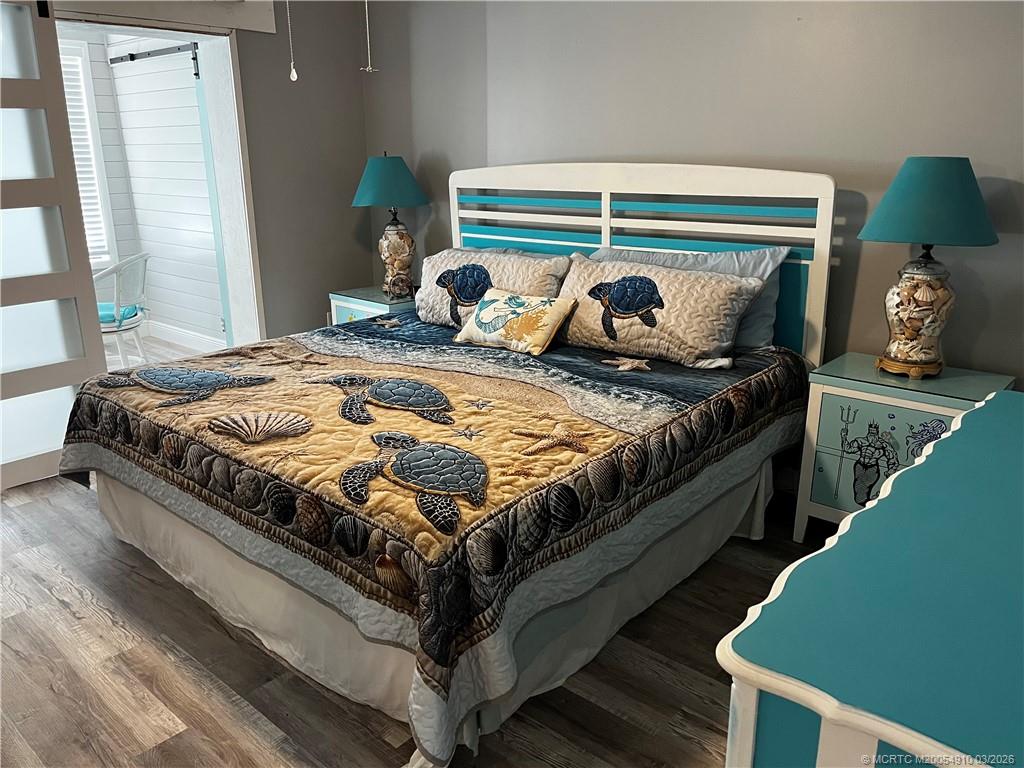 5323 Southeast Miles Grant Road, Unit 206 Stuart, FL 34997 - Photo 11 of 20 a bedroom with a bed and a window