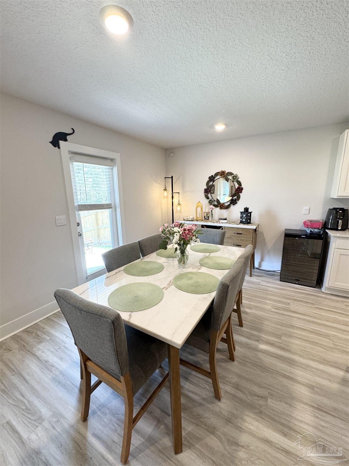 3315 Garganey Road Pace, FL 32571 - Photo 11 of 52 a view of a dining room with furniture and wooden floor