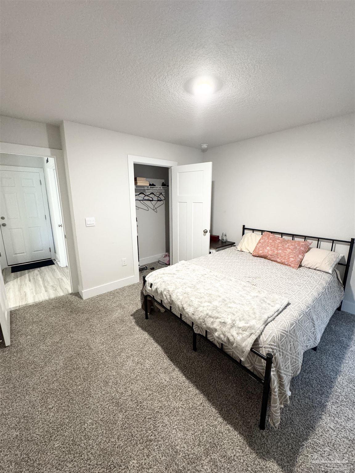3315 Garganey Road Pace, FL 32571 - Photo 15 of 52 a bedroom with a bed and wooden floor