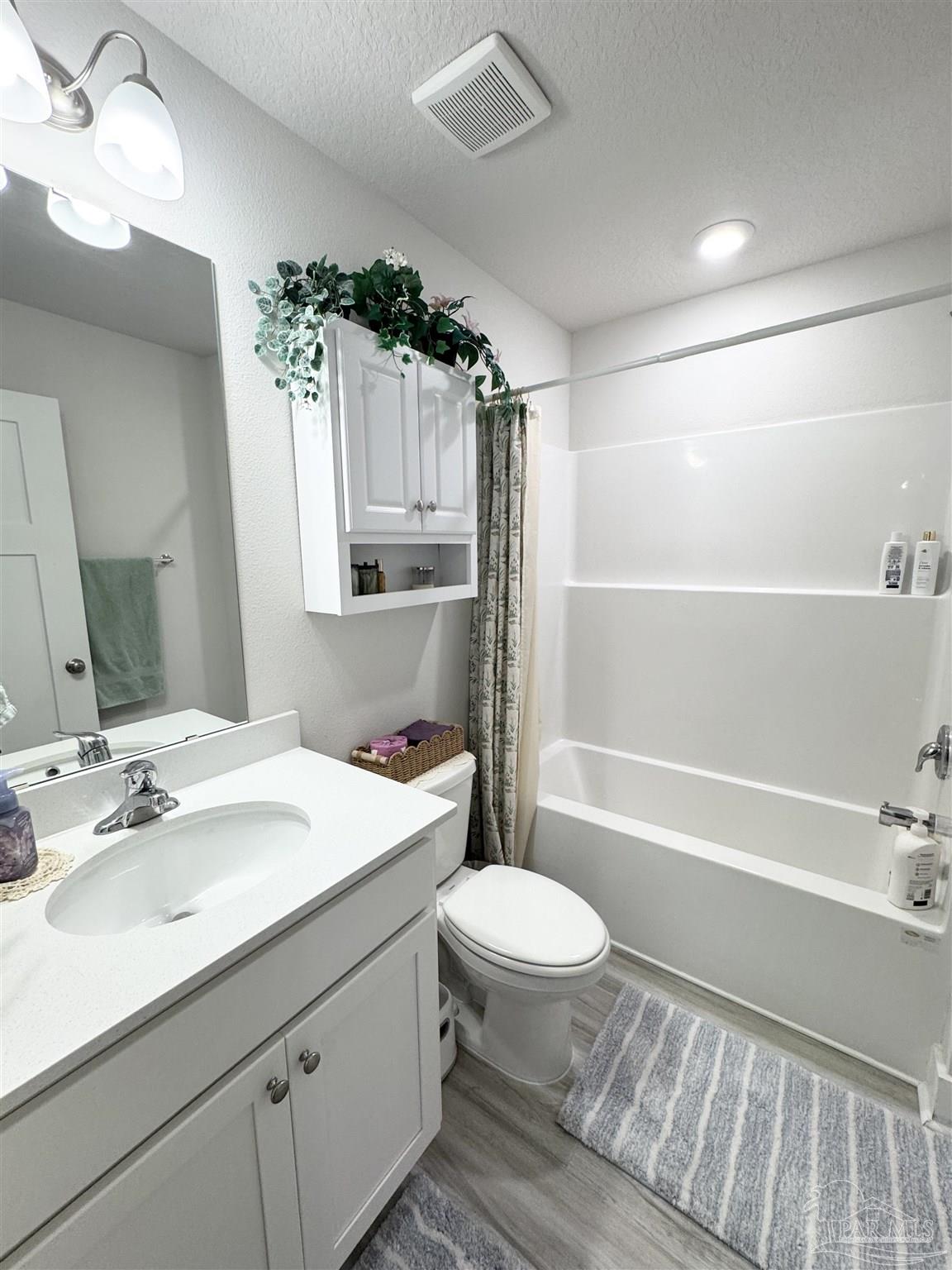 3315 Garganey Road Pace, FL 32571 - Photo 17 of 52 a bathroom with a sink a toilet a mirror and shower