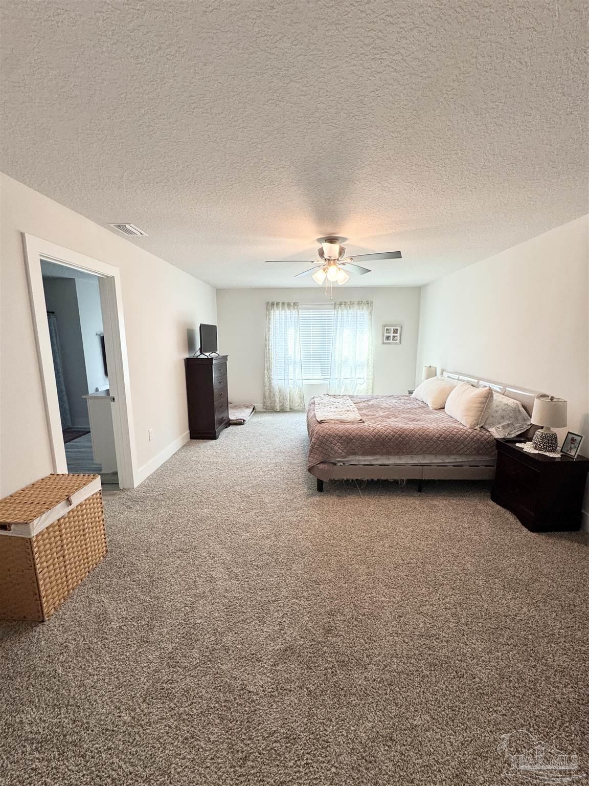 3315 Garganey Road Pace, FL 32571 - Photo 19 of 52 a bedroom with bed and window