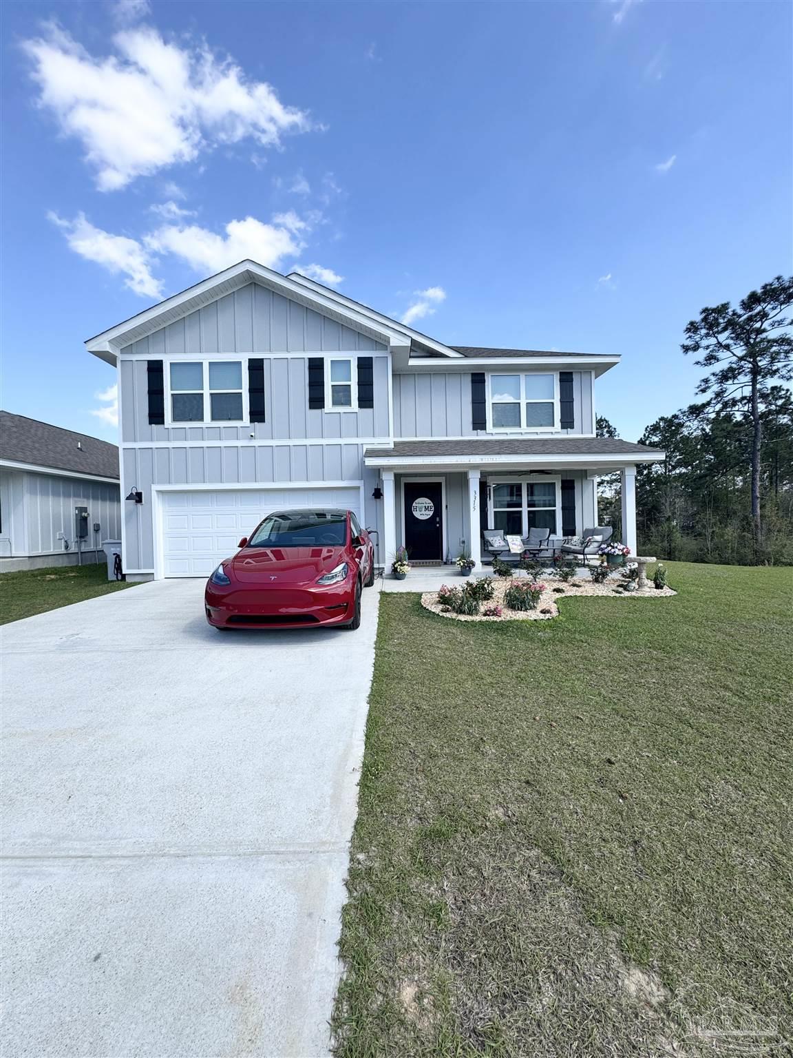 3315 Garganey Road Pace, FL 32571 - Photo 2 of 52 a front view of a house with garden