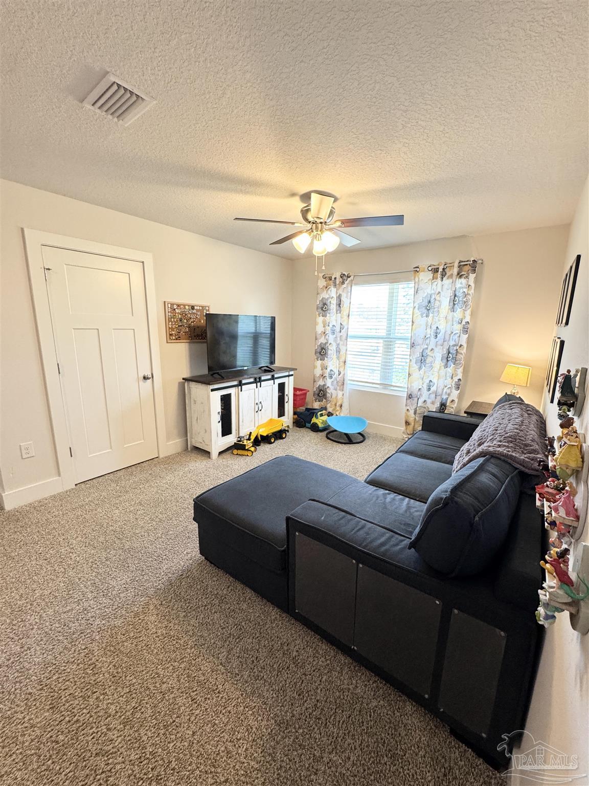 3315 Garganey Road Pace, FL 32571 - Photo 28 of 52 a living room with furniture and a flat screen tv
