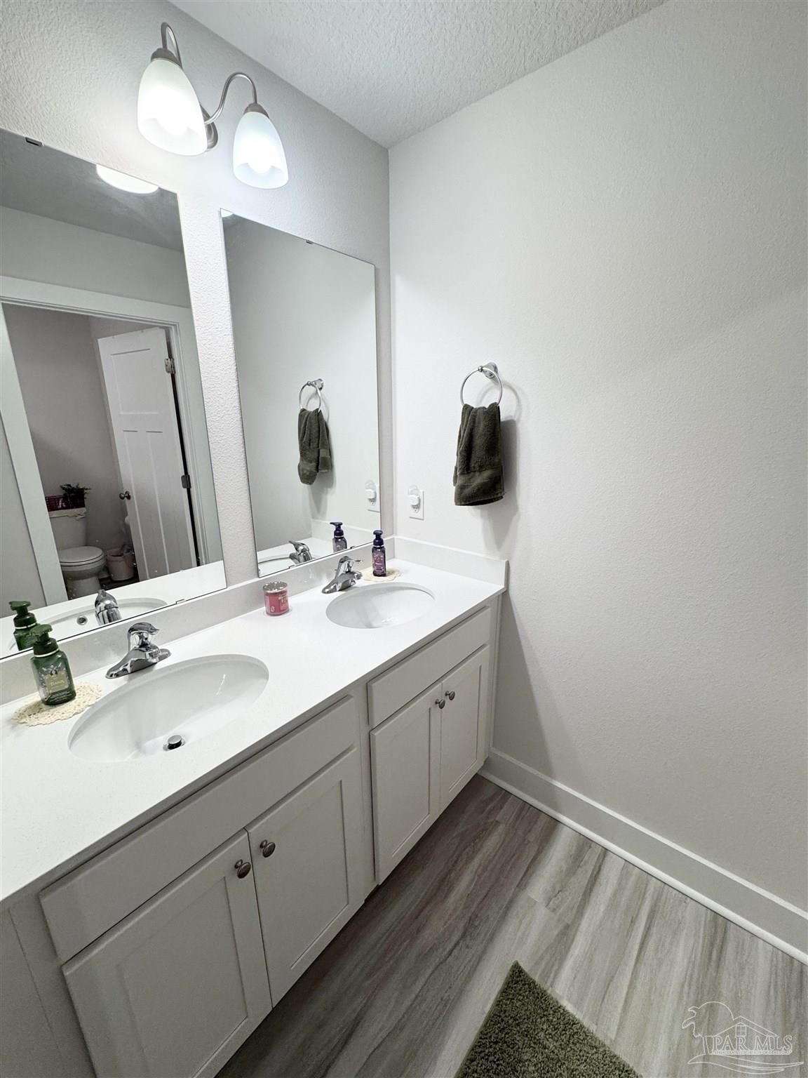 3315 Garganey Road Pace, FL 32571 - Photo 31 of 52 a bathroom with a double vanity sink and a mirror
